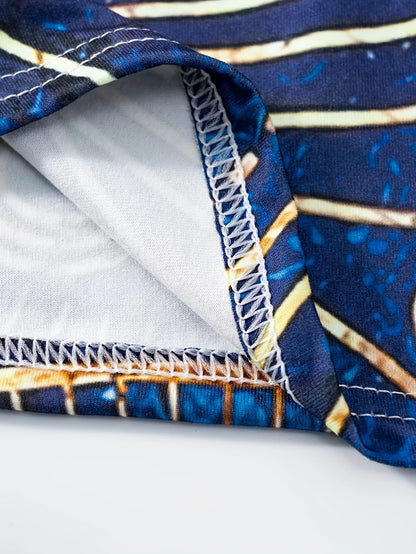 Bohemian-inspired maxi dress featuring a vibrant blue-and-gold totem print. Halter-neck, sleeveless cut with a slim fit and flow