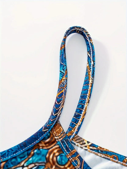 Bohemian-inspired maxi dress featuring a vibrant blue-and-gold totem print. Halter-neck, sleeveless cut with a slim fit and flow